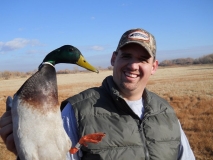 Ryan Garrett, the 2010 State Duck Calling Champion, shows off a nice mallard drake during a banding operation at Bosque Del Apache NWR.