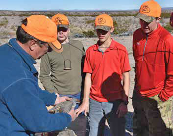 Tim Mitchusson, a retired Game and Fish biologist now with the Friends of the Bosque del Apache, shows youth hunters how to age their quail harvest. New Mexico Wildlife magazine, NMDGF