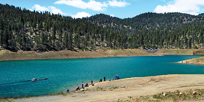 Grindstone Reservoir, nestled in the cool pine forest of the Sacramento Mountains, offers anglers in the southeastern portion of the state opportunities to wet a line for rainbow trout. Photo by Mark Madsen, New Mexico Wildlife magazine, NMDGF.