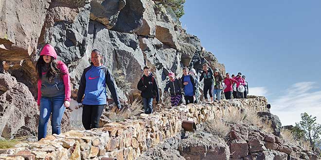 Julianna Sandoval and Anastacia Gonzalez, from Questa Junior and Senior High School take the lead down to the Rio Grande. The 47 students from Questa are members of the Junior and Senior Honor Society. Photo by Zen Mocarski, New Mexico Wildlife magazine, NMDGF.