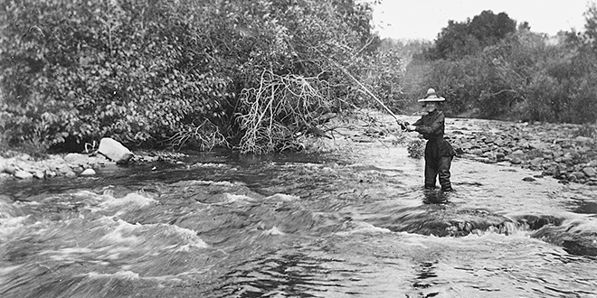 1915 fashion statement: woman fly fishing with hipwaders over dress. Photo: Museum of New Mexico, Neg. No. 21929. (Making Tracks: A Century of Wildlife Management. New Mexico Wildlife magazine. (A history of the New Mexico Department of Game and Fish, NMDGF).