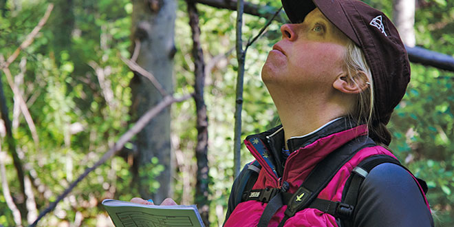 Kirsten Cruz-McDonnell, chief biologist for Envirological Services, Inc., walked a predetermined route in the Santa Fe National Forest, stopping at up to 20 points for 10 minutes identifying different bird species primarily by their calls. Photo by Zen Mocarski, New Mexico Wildlife magazine Spring 2017 Vol60, Num1, New Mexico Department of Game and Fish.